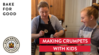 Mother and daughter in the process of baking crumpets